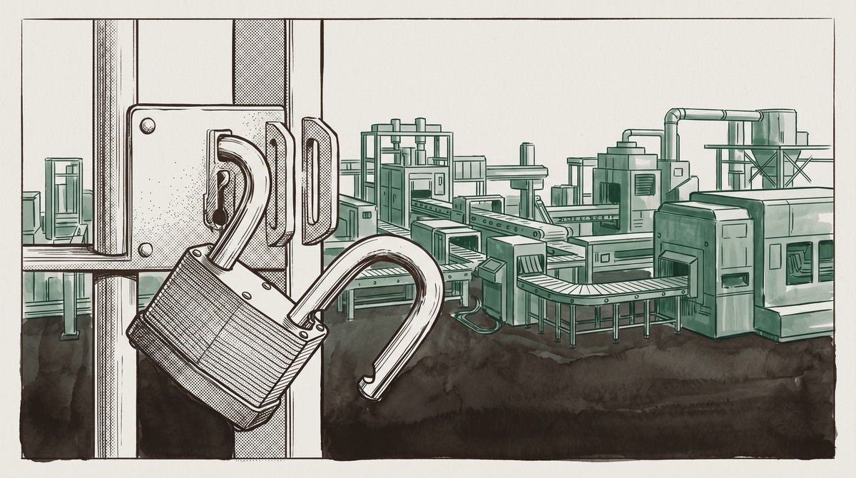 An open padlock hangs from an industrial gate before a silent factory floor — conveyor belts and machinery behind it, nobody watching.