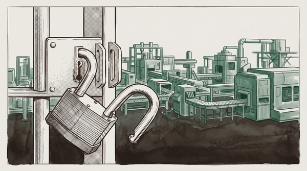 An open padlock hangs from an industrial gate before a silent factory floor — conveyor belts and machinery behind it, nobody watching.