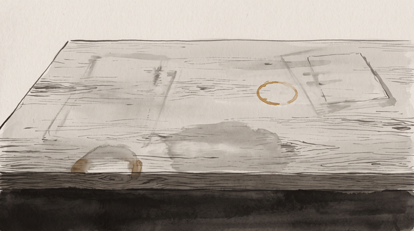 An empty desk surface with an amber coffee ring and faint residual marks of sustained labor, the maker absent. Pale grey field, dark ink, amber-brown accent.